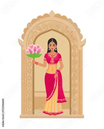 Indian woman in traditional dress stands inside ornate archway holding lotus flowers in her hand