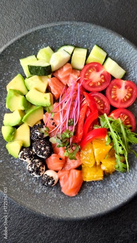 Bowl with salmon pieces, cheese, tomatoes, peppers and avocado. Salmon bowl as a food background for your design