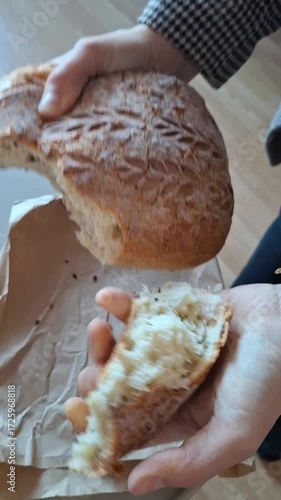 Freshly baked bread crunches in your hands. Sourdough bread.