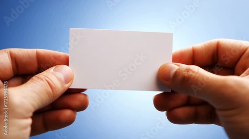 Hands holding blank business card