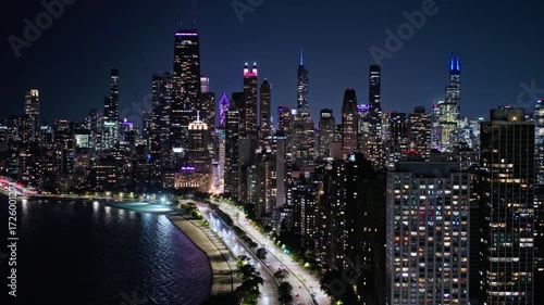 Wallpaper Mural Chicago skyline glows with city lights at night along lake michigan Torontodigital.ca
