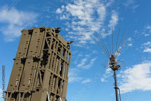 Anti aircraft defense system. Ground based surface to air missile. Military equipment to defend and protect agaisnt aerial threat. Device and blue sky with white clouds.
