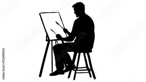 Silhouette of a male artist sitting and painting on a canvas.
