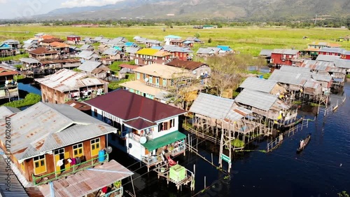 Aerial view of stilt houses in inle lake, myanmar, with mountains in background