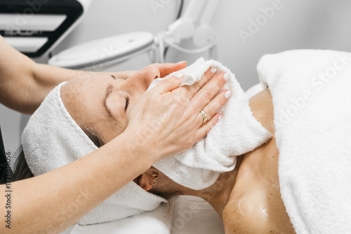 Woman receiving RF lifting treatment for facial rejuvenation, relaxing on treatment bed with soothing ambiance, showcasing advanced skincare technology and professional care