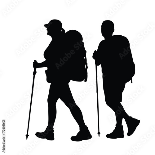 Hiking silhouette of couple with backpacks and trekking poles enjoying outdoor adventure travel trip