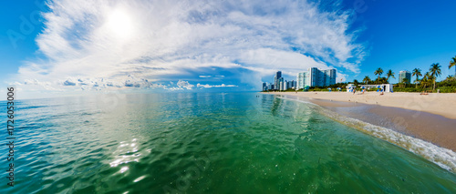 Fototapeta Naklejka Na Ścianę i Meble -  South Florida Beach Life. Urban Skyline Meets Relaxing Ocean Shore
