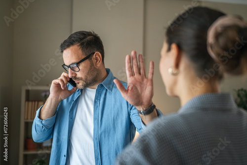 Man making phone call ignoring woman