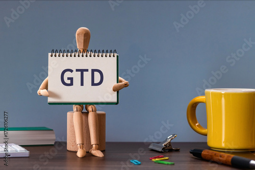 There is notebook with the word GTD. It is an abbreviation for Getting Things Done as eye-catching image.