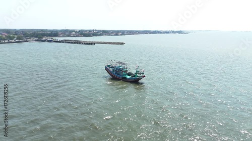 Aerial View Captures Tranquil Scene of a Boat on Sparkling Sea