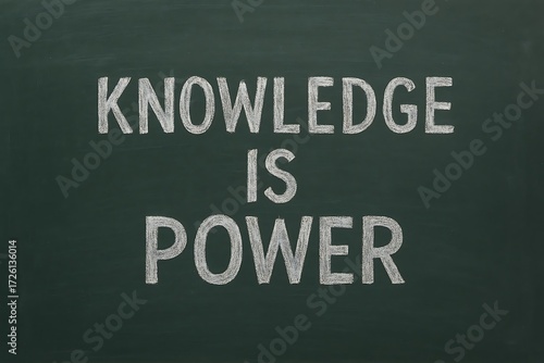 Inspirational quote knowledge is power written in chalk on a dark blackboard for education and learning concepts