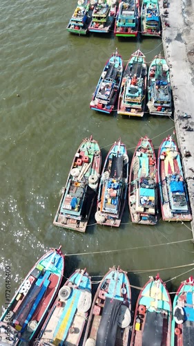 Aerial Display of Fishing Boats Gathering in Coastal Harbor Landscape
