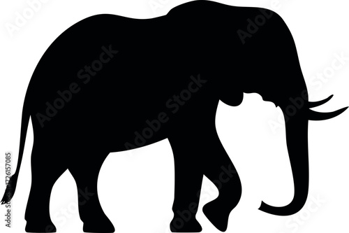 Silhouette of an elephant walking, showcasing its trunk, tusks, and powerful build.