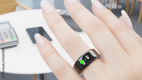 Close-up of a hand wearing a smart ring for contactless payment at a cafe.