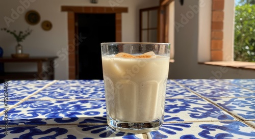 Creamy beverage in glass on patterned tabletop