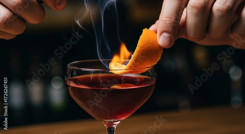 Flaming orange twist over cocktail