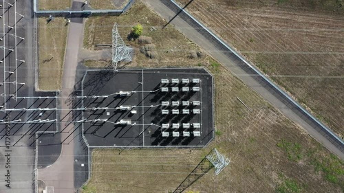 4K aerial drone footage of large electric power substation and high voltage power lines in Hillsboro Oregon, showing transmission towers, transformers, and distribution infrastructure from above