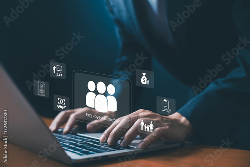 Businessman typing on laptop with digital icons of employee benefits, salary, family support, insurance, and corporate perks, symbolizing HR management, workplace welfare, and organizational support.