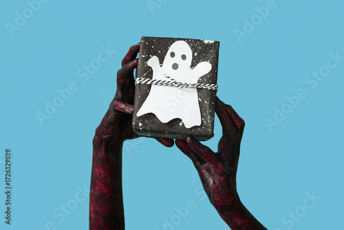 Hands of zombie with gift b...
