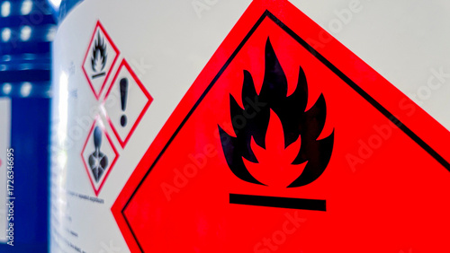 Flammable icon label on chemical storage tank indicating fire hazard, symbolizing safety, warning, awareness,