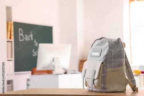 Stylish backpack on desk in...