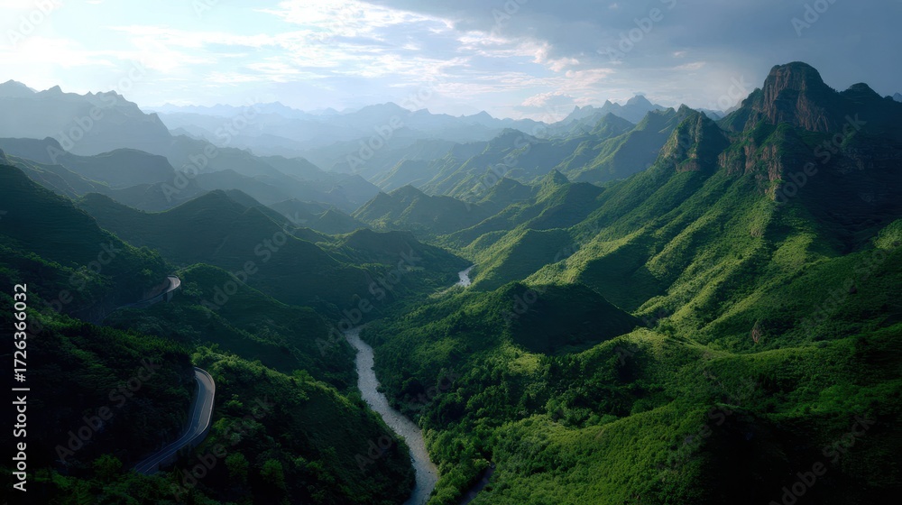 Fototapeta premium Lush Green Mountain Range with Winding River Valley