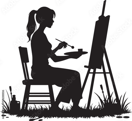 Black silhouette of woman painting on easel outdoors