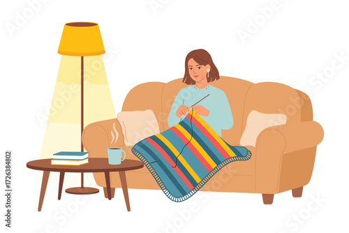 Woman Relaxing and Knitting on Sofa at Home under Lamp Light, Enjoying Coffee and a Cozy Hobby, Relaxing in Tranquility