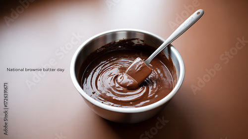 A bowl of rich brownie batter with a spatula, celebrating National Brownie Batter Day