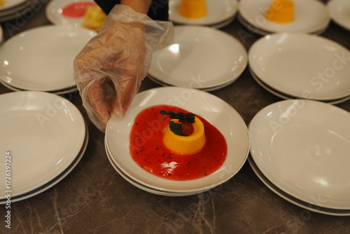 Desserts are being served, with strawberry sauce and garnish.
