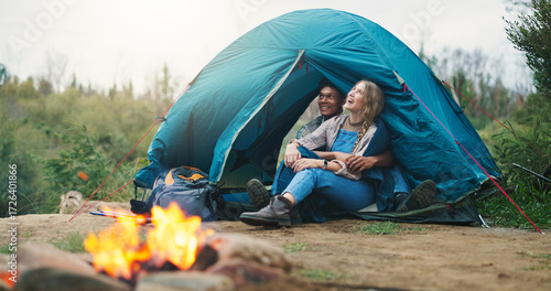 Wallpaper Mural Happy couple, tent and relax with fire for camping, outdoor vacation or holiday together in nature. Man, woman or love with smile, flame or shelter for safety, security or protection in wilderness Torontodigital.ca