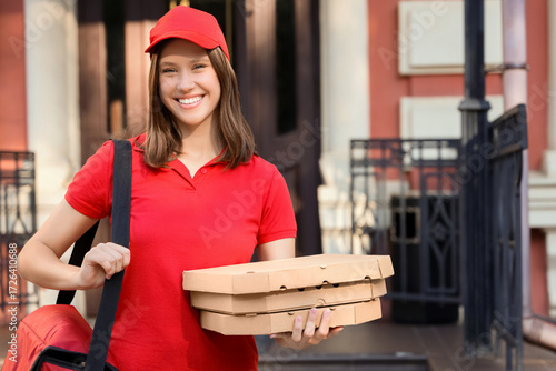 Female courier with pizza b...