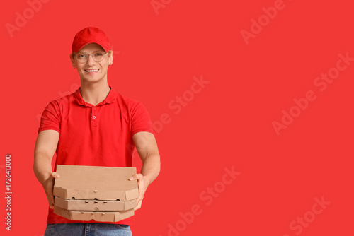 Male courier with pizza box...