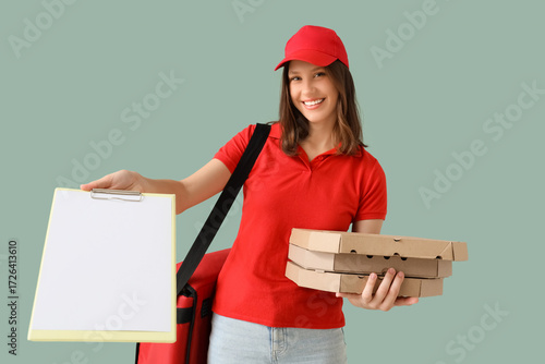 Female courier with pizza b...