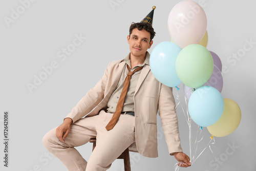 Happy young man with balloo...