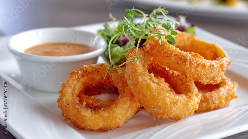 american onion rings close up, golden fried rings, crispy texture, served with dipping sauce, elegant plate, fine dining style