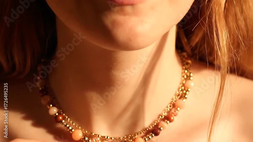 Close Up of a Woman Putting On a Beautiful Beaded Necklace.