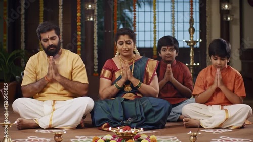 Indian Hindu Family Performing Prayer Rituals Together in Traditional Attire