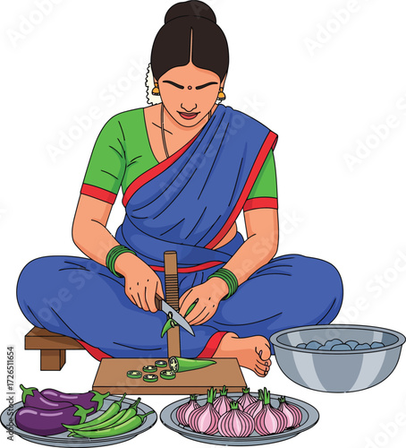 Indian woman in traditional saree preparing food sitting on floor