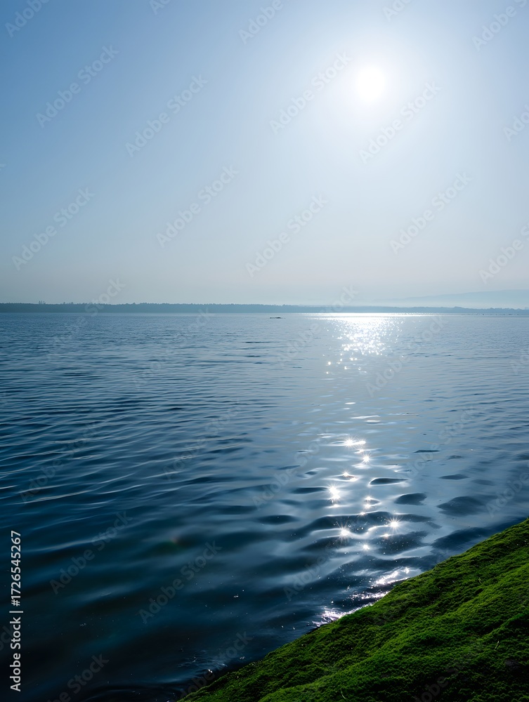 Obraz premium A serene lake reflects the sun creating a beautiful shimmering effect on the water surface and sky 90