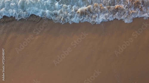 Ocean wave hitting sandy coast from above, clear water and ripple texture, calm seascape, exotic summer beach, ideal for vacation, travel, tourism, nature 