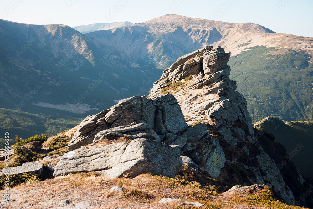 Fototapeta premium Rugged Mountain Peak with Distant Hills