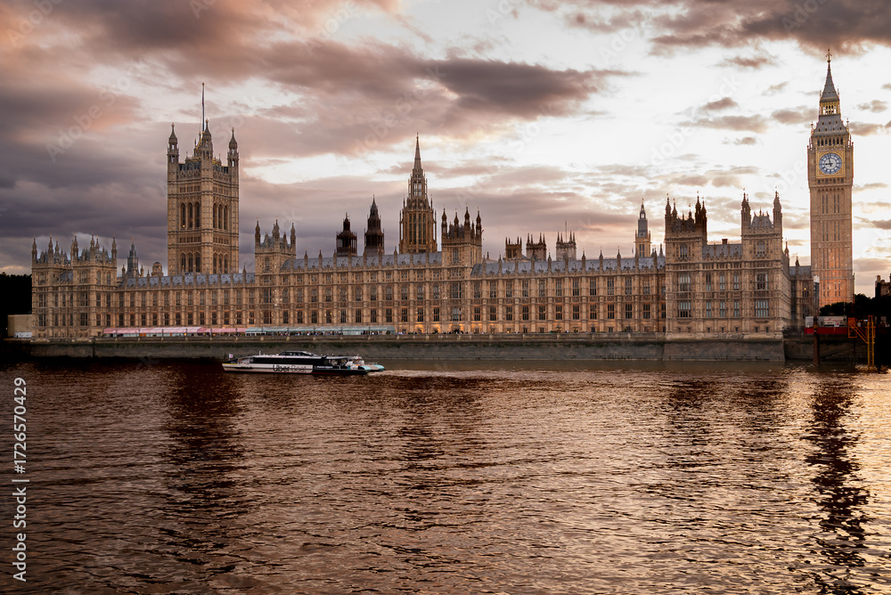 Naklejka premium London, UK - evening view on Big Ben, Houses of parliament and River Thames in city of Westminster - urban skyline