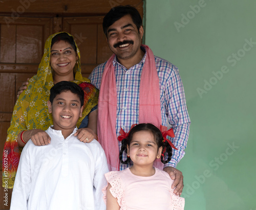 Obraz na płótnie Indian happy rural family standing at the house village