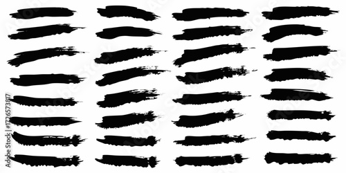 Collection of black ink brush strokes and paint splatters on a white background