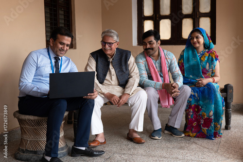 Cuadro en lienzo Indian happy rural family with agronomist or banker use laptop