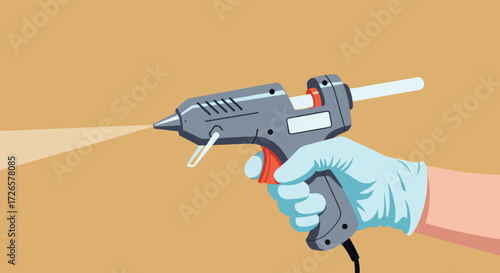 A gloved hand uses a hot glue gun to dispense adhesive for crafting projects.