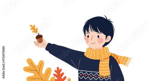 A young boy wearing a scarf and holding an acorn with an autumn leaf.