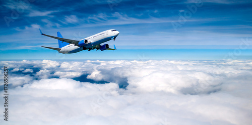 Airplane flying over the clouds, travel background with white plane in the flight