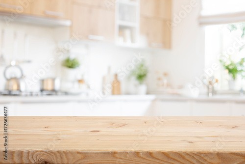 Empty wooden table for food presentation with bright blurred kitchen interior background